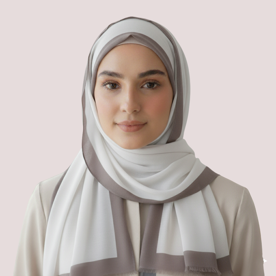 Woman wearing a striped hijab against a light pink background