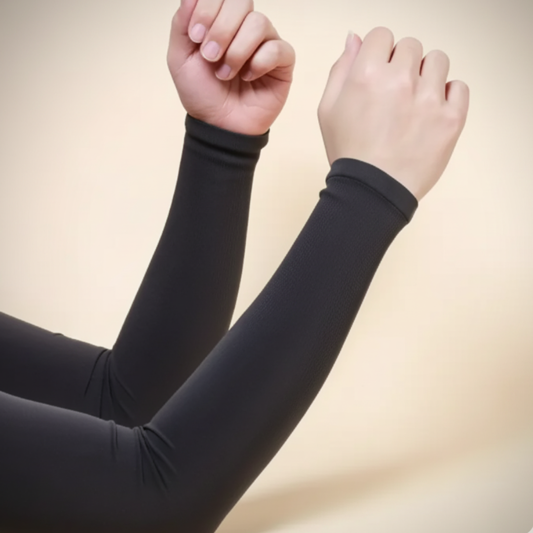 Black arm sleeves worn on arms against a beige background