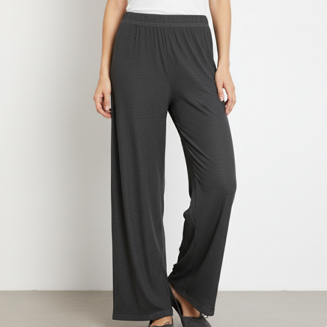 Dark gray wide-leg pants worn by a person on a light gray background