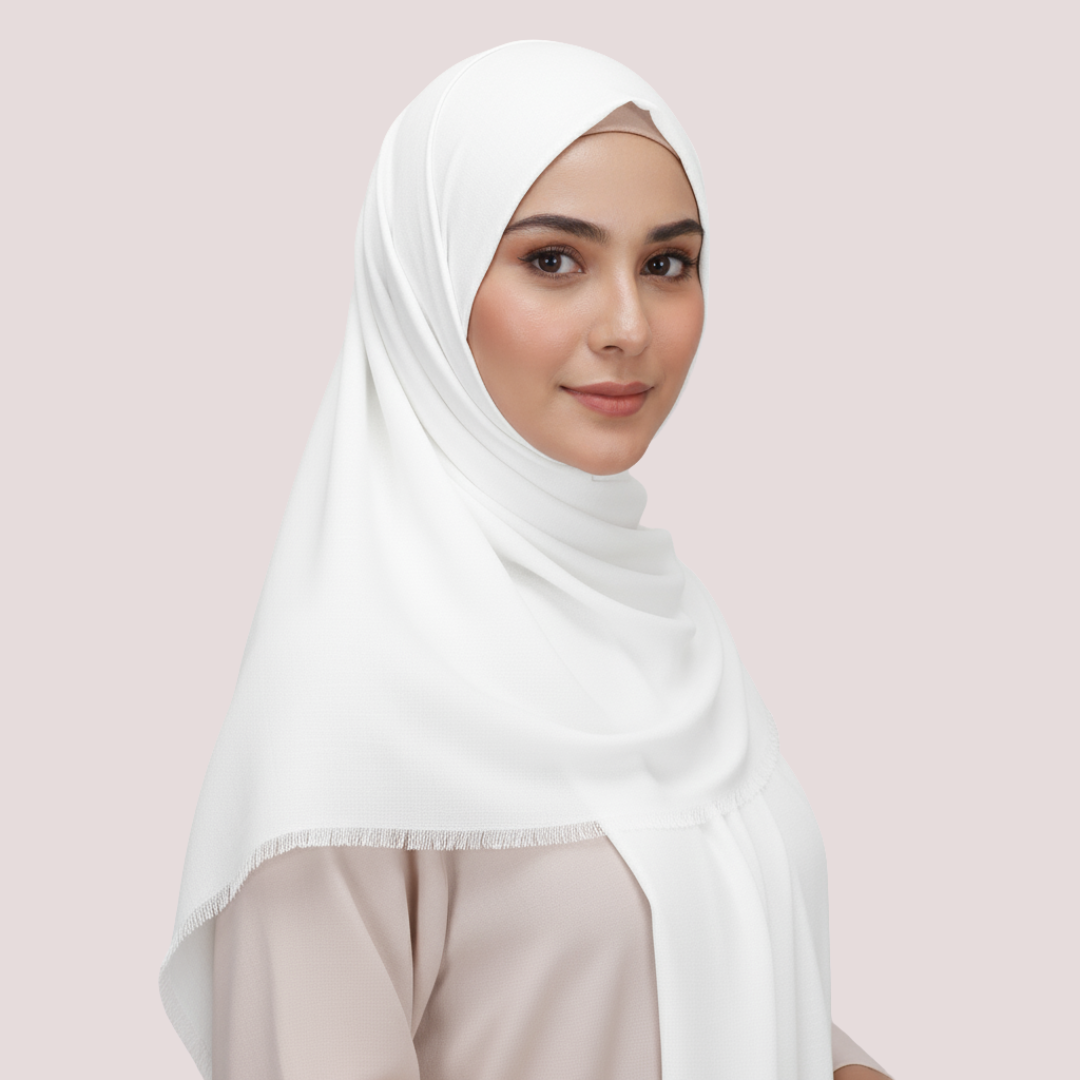Woman wearing a white hijab against a light pink background