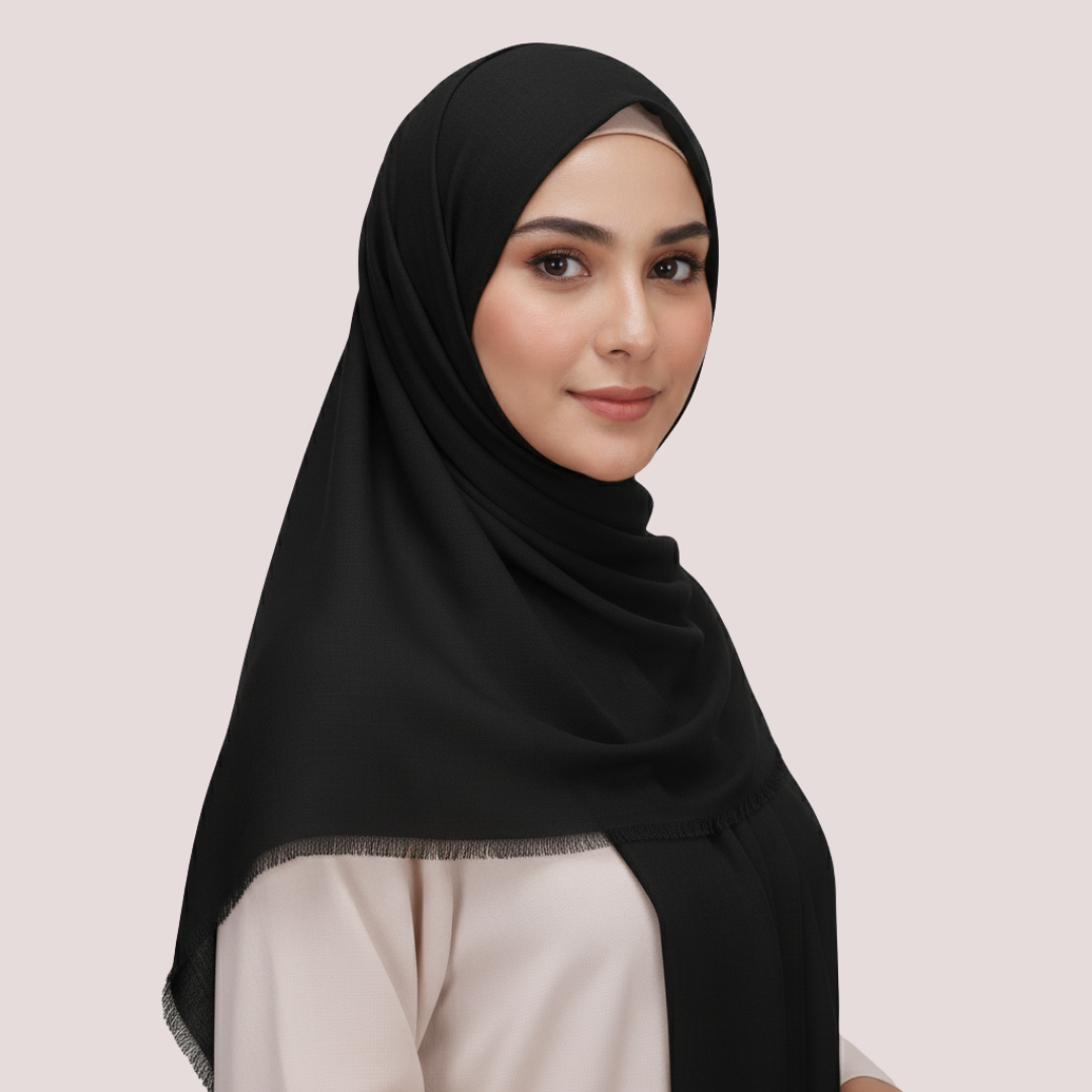 Woman wearing a black hijab on a light pink background